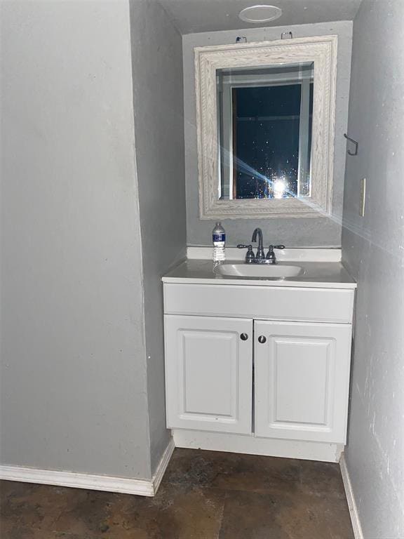 bathroom with vanity and baseboards