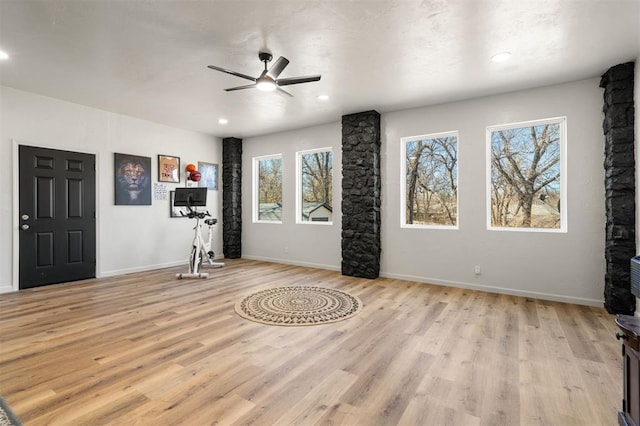 interior space featuring baseboards, recessed lighting, a wealth of natural light, and light wood-style floors