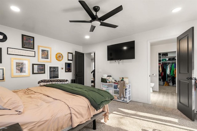 carpeted bedroom with recessed lighting, ceiling fan, a spacious closet, and baseboards