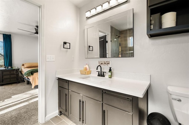 ensuite bathroom with ceiling fan, toilet, connected bathroom, and vanity