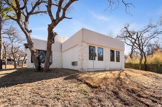 exterior space with fence and stucco siding