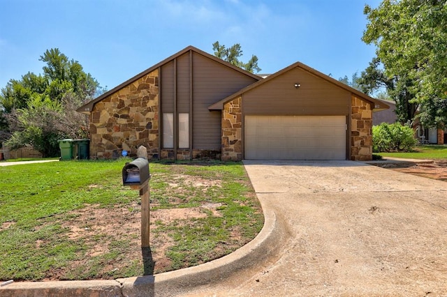 mid-century home with a garage, stone siding, concrete driveway, and a front yard