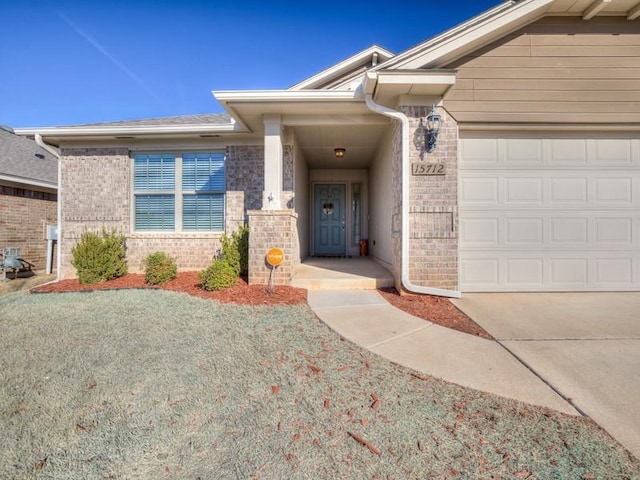 property entrance featuring brick siding and an attached garage