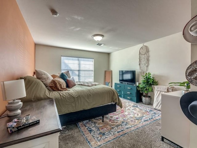 bedroom featuring carpet floors and visible vents