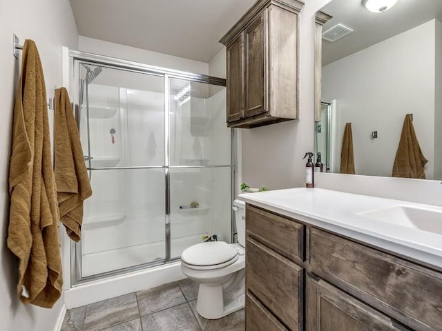 full bathroom with toilet, visible vents, a stall shower, and vanity