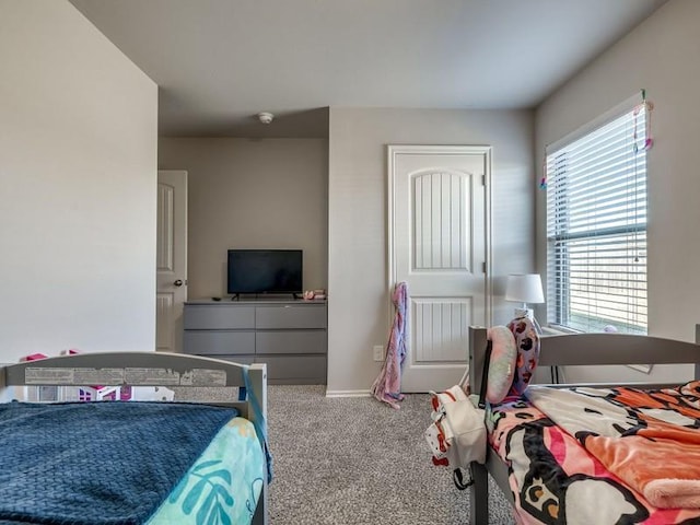 bedroom with carpet and baseboards