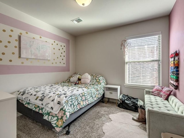 carpeted bedroom featuring visible vents