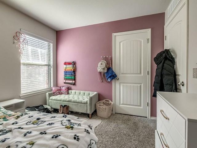 carpeted bedroom featuring visible vents