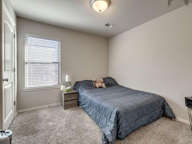 bedroom featuring carpet, visible vents, and baseboards