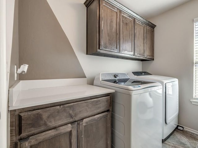 clothes washing area with cabinet space and washer and dryer