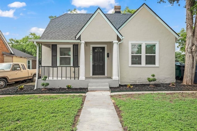 bungalow-style home featuring a shingled roof, covered porch, and stucco siding