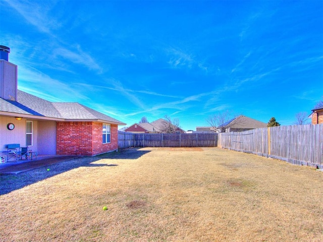 view of yard featuring a patio area and a fenced backyard