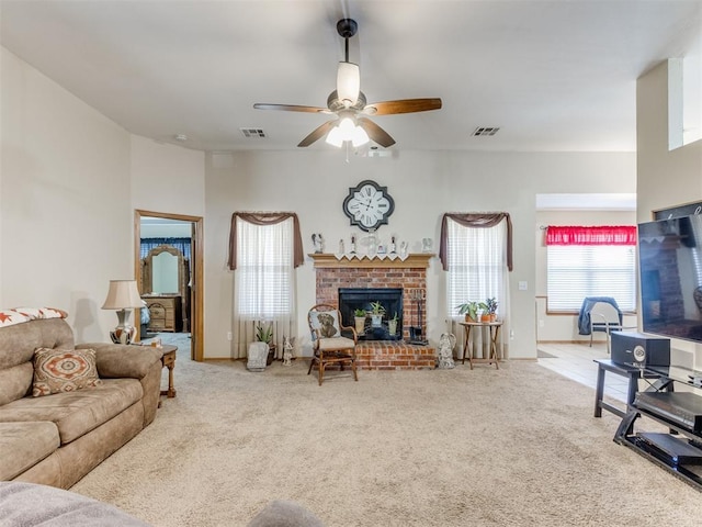 living room with carpet, a fireplace, and visible vents