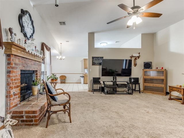 living room with ceiling fan with notable chandelier, a brick fireplace, carpet flooring, and visible vents