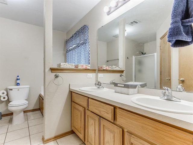 full bathroom featuring tile patterned floors, a sink, toilet, and a shower stall