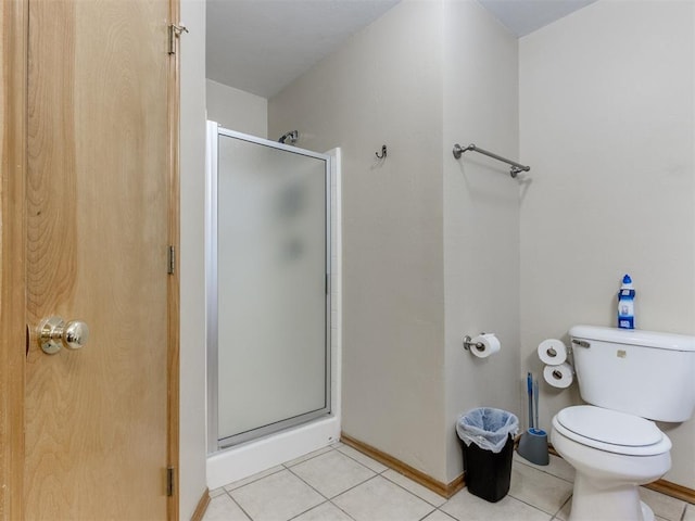 full bathroom with a stall shower, toilet, and tile patterned floors