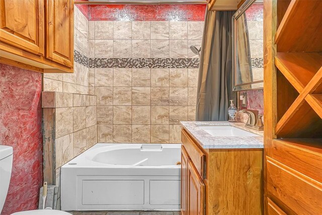 bathroom featuring bathtub / shower combination, vanity, and toilet