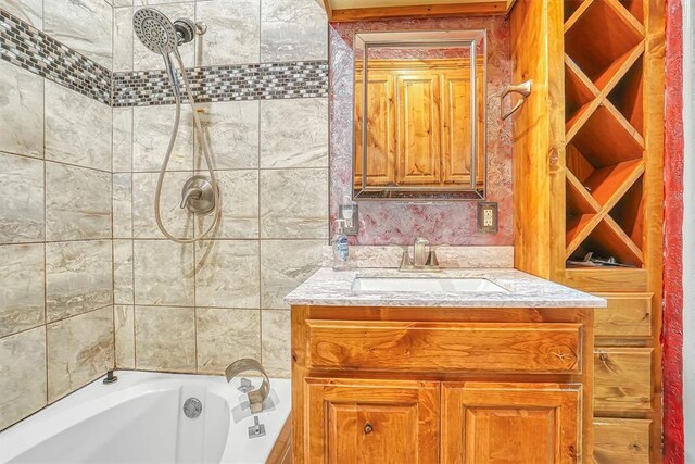 full bathroom featuring tiled shower / bath combo and vanity