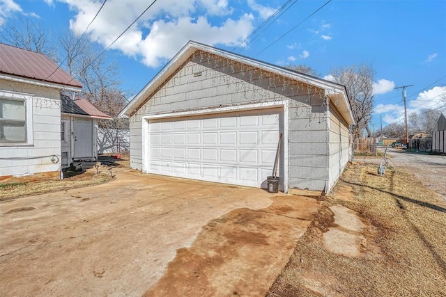 detached garage featuring fence