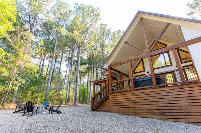 view of home's exterior with an outdoor fire pit and stairway