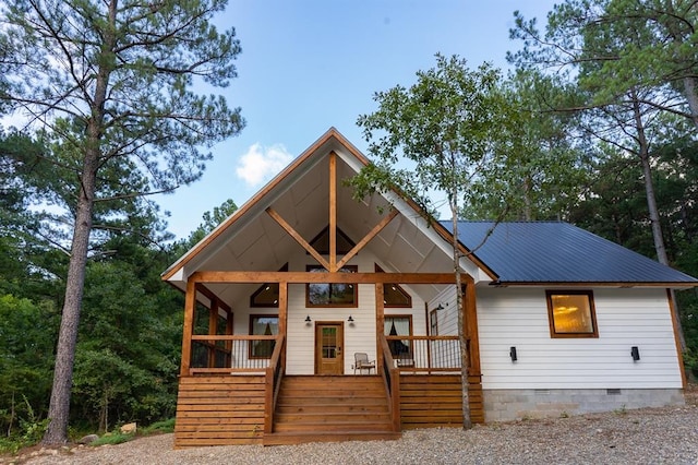 view of front of house with crawl space, a porch, and metal roof