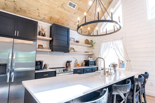 kitchen with open shelves, stainless steel appliances, light countertops, wood ceiling, and wall chimney exhaust hood