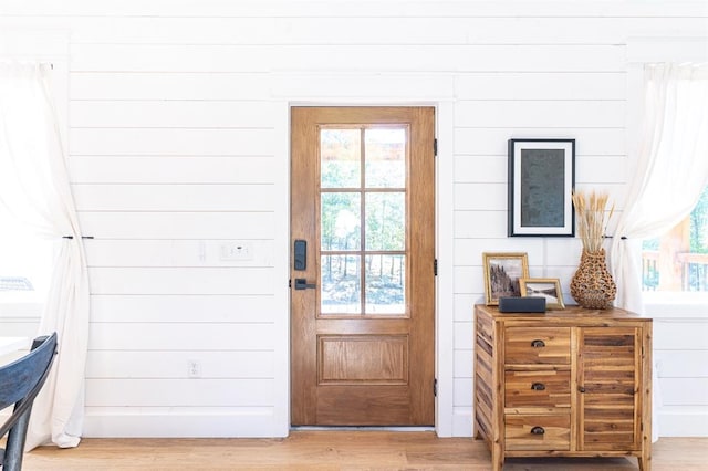 doorway to outside featuring light wood finished floors and a wealth of natural light