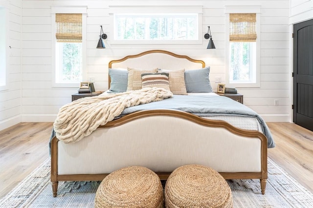 bedroom featuring baseboards and wood finished floors