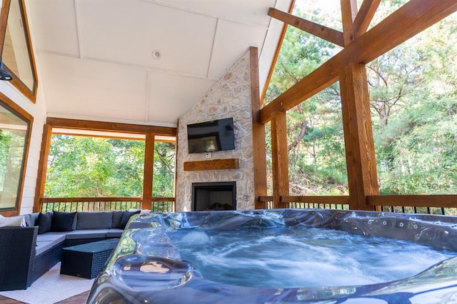 sunroom / solarium featuring lofted ceiling and a jacuzzi