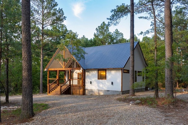 chalet / cabin with crawl space, metal roof, and gravel driveway