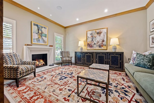 living room with recessed lighting, a lit fireplace, and ornamental molding