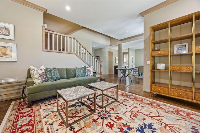 living area with baseboards, stairs, and wood finished floors