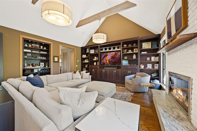 living room featuring vaulted ceiling with beams, a brick fireplace, dark wood-style floors, and built in shelves