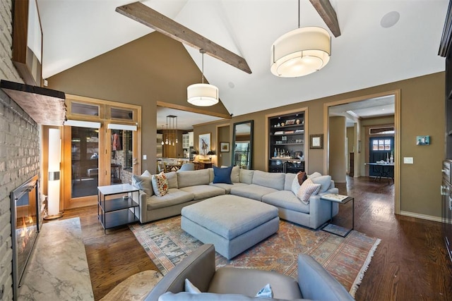 living area with beam ceiling, high vaulted ceiling, a fireplace, and wood finished floors