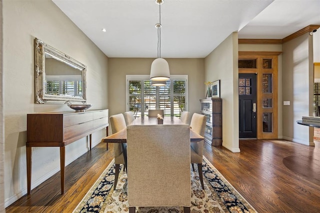 dining room with dark wood-style flooring and baseboards