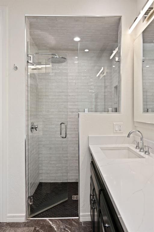 bathroom featuring vanity and a shower stall
