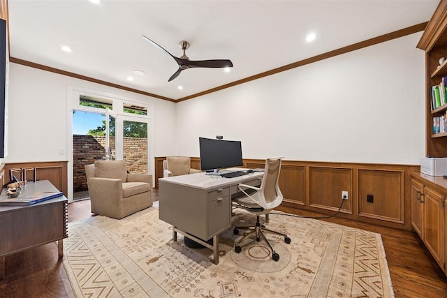 office featuring a wainscoted wall, ceiling fan, ornamental molding, and light wood-style flooring