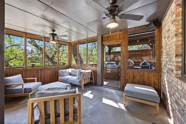 sunroom featuring ceiling fan, an outdoor hangout area, and area for grilling
