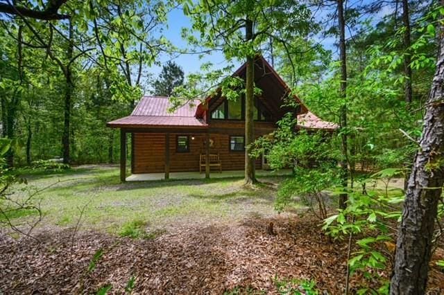 back of property featuring metal roof