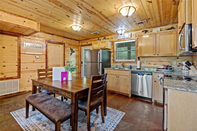 dining area featuring wooden ceiling, visible vents, and wood walls