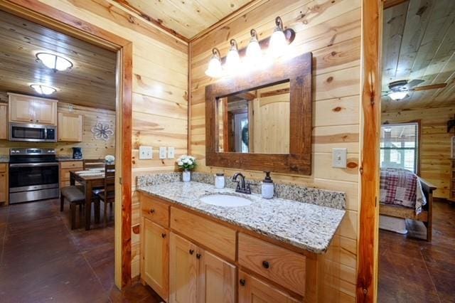 bathroom with wood walls, wooden ceiling, and vanity