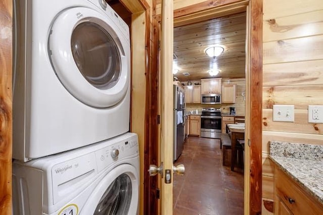 clothes washing area with wooden ceiling, laundry area, and stacked washer and clothes dryer