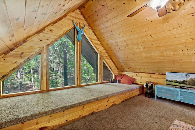 unfurnished bedroom featuring multiple windows, carpet floors, wood walls, and wood ceiling