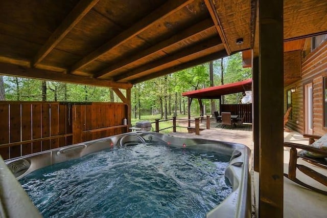 view of swimming pool featuring a patio area, a hot tub, and fence