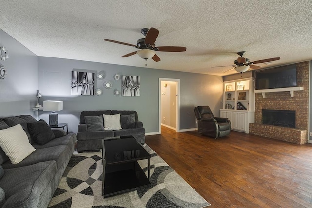 living area with a textured ceiling, wood finished floors, and ceiling fan