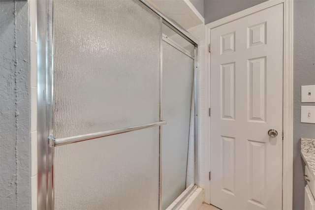 bathroom with a shower stall