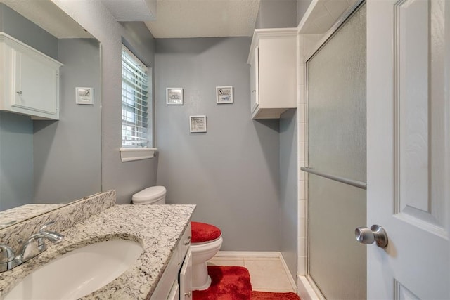 full bathroom with toilet, a shower stall, tile patterned floors, vanity, and baseboards