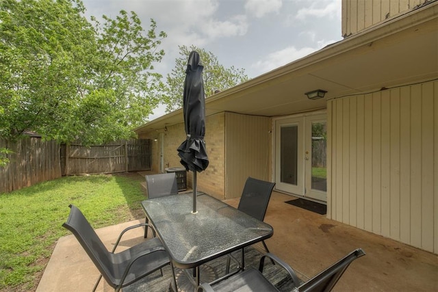 view of patio with french doors, outdoor dining area, and central air condition unit