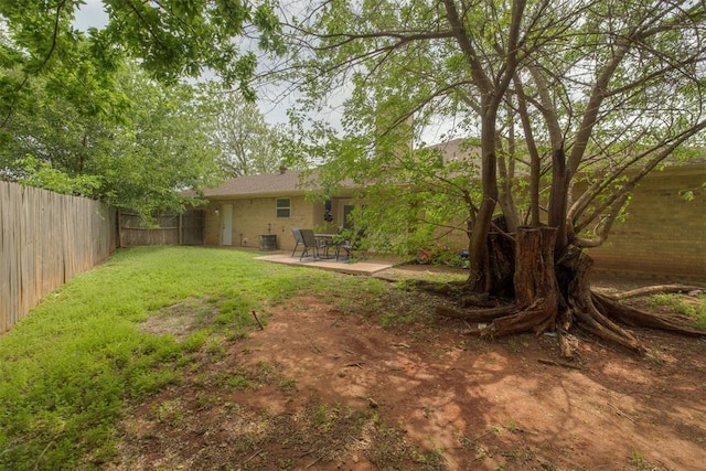 view of yard with a patio area, central AC unit, and a fenced backyard