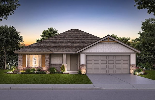 view of front of house featuring a garage, concrete driveway, a yard, and brick siding